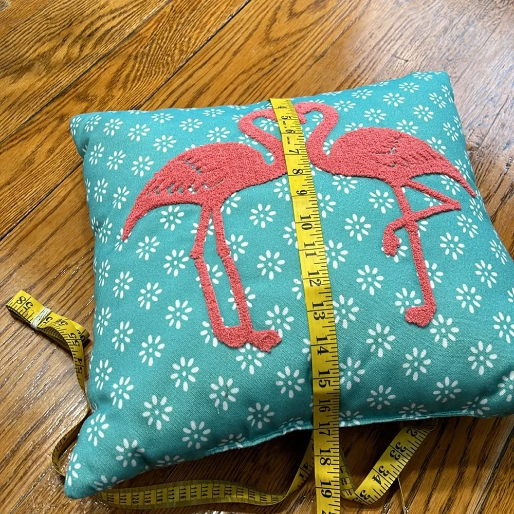 Aqua fabric pillow with hook and loop flamingo decoration.